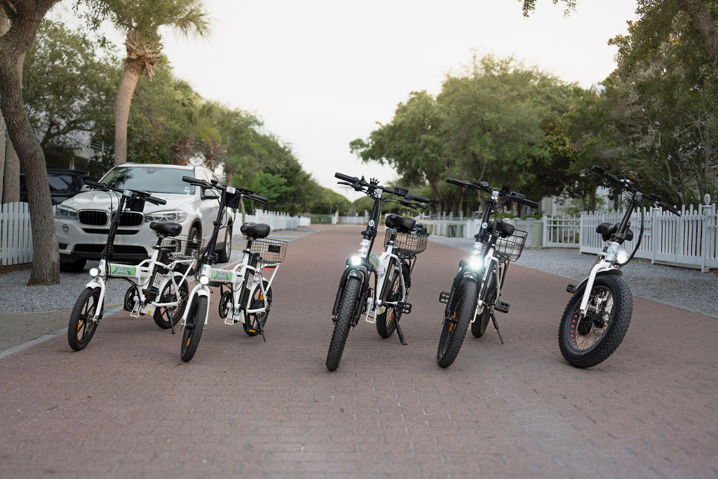 Fleet of Salty Spokes e-bikes lined up at sunset