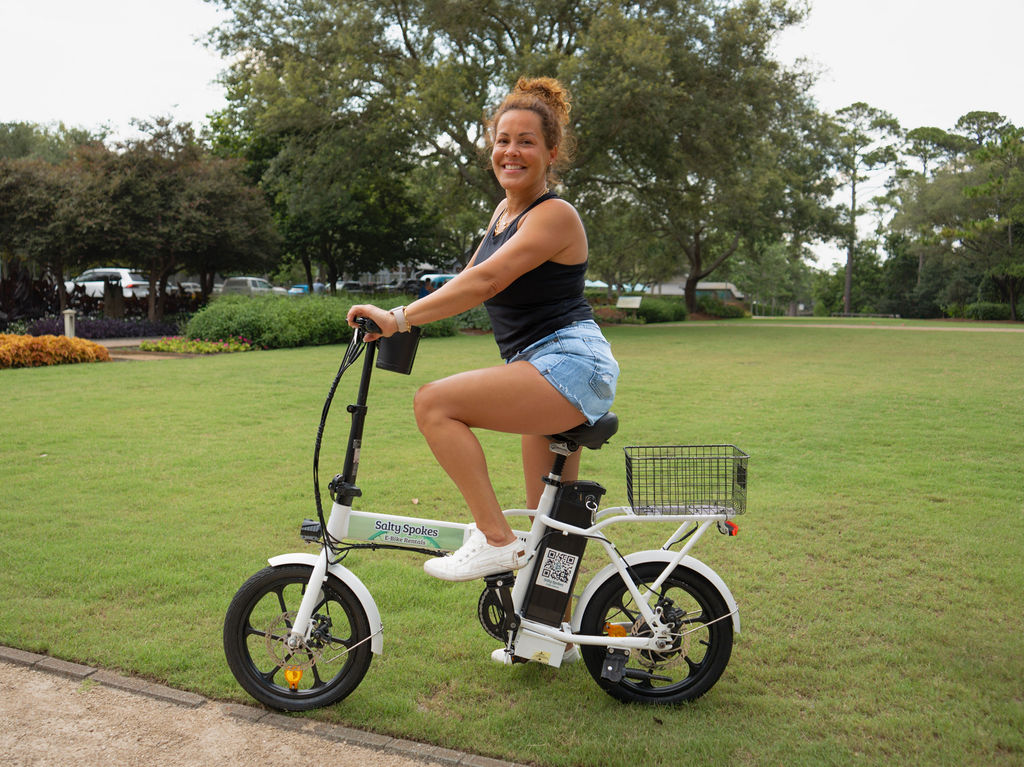 Woman riding a Salty Spokes e-bike on the green